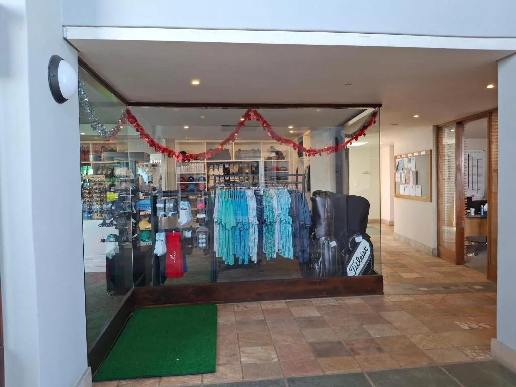 Retail shop storefront with clothing displays and holiday decorations