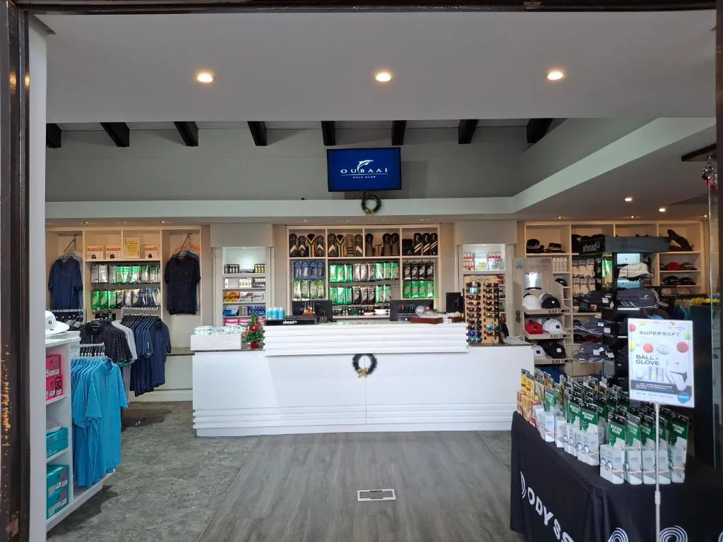 Interior view of Oubaai Golf Estate retail shop with counter and merchandise displays