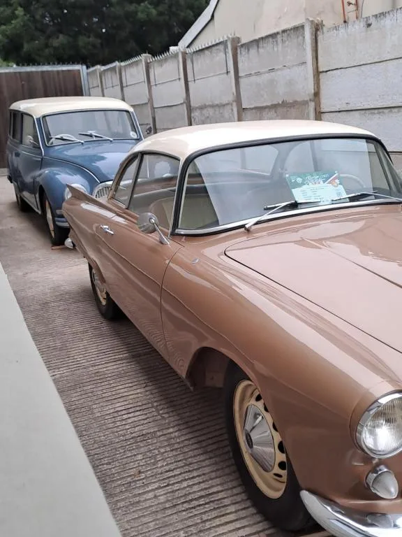 Vintage classic cars parked on brick driveway near property