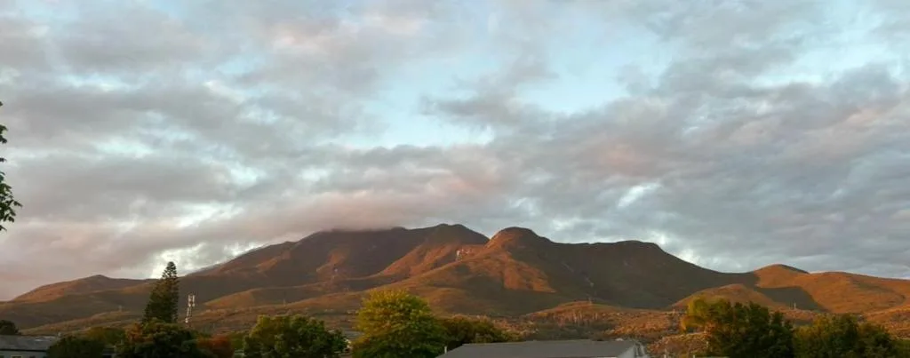 Mountain landscape with golden light at sunset over green valleys