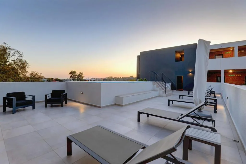 Spacious rooftop deck with loungers and seating at sunset