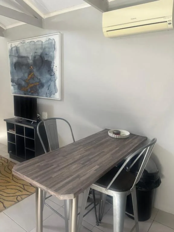 Modern workspace with dining table, chairs, and abstract wall art