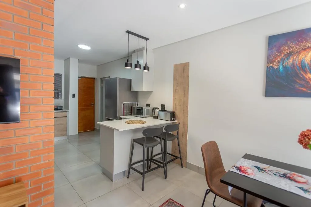 Modern kitchen with island counter, bar seating, and pendant lighting fixtures