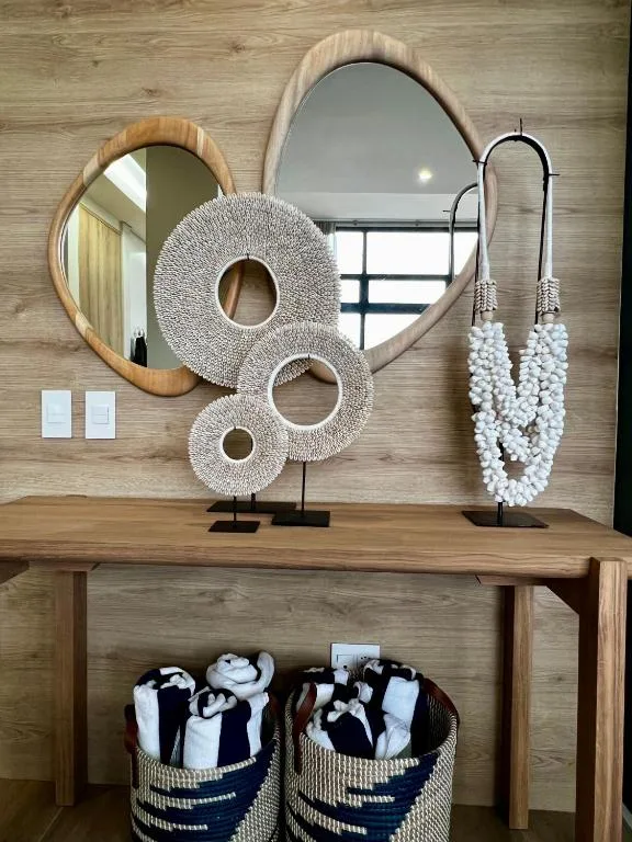 Stylish bathroom vanity with decorative mirrors, woven accents, and storage baskets