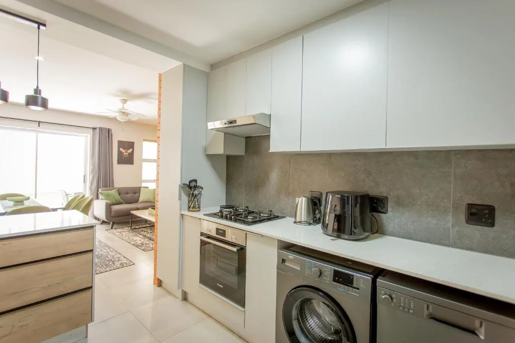 Modern kitchen with white cabinetry, gas cooktop, and stainless steel appliances