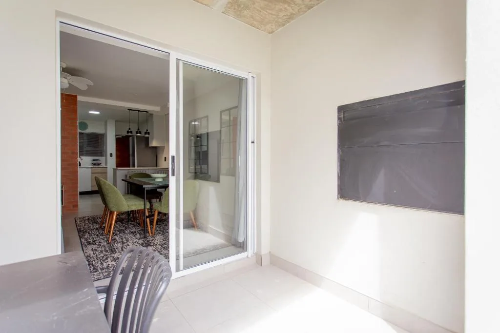 Modern lounge with sliding glass doors opening to dining and kitchen areas