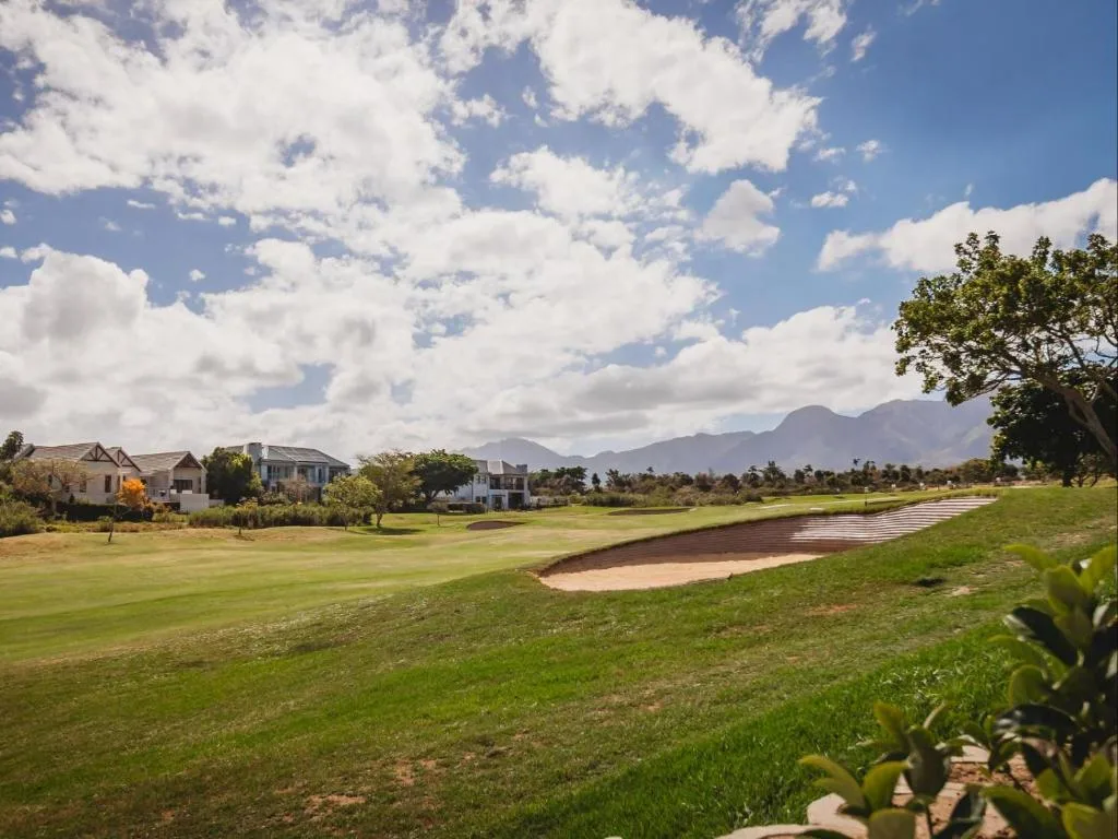 Mountain views across manicured golf course lawns and property grounds
