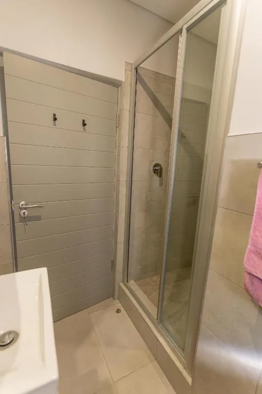 Modern bathroom with walk-in shower enclosure and tiled walls