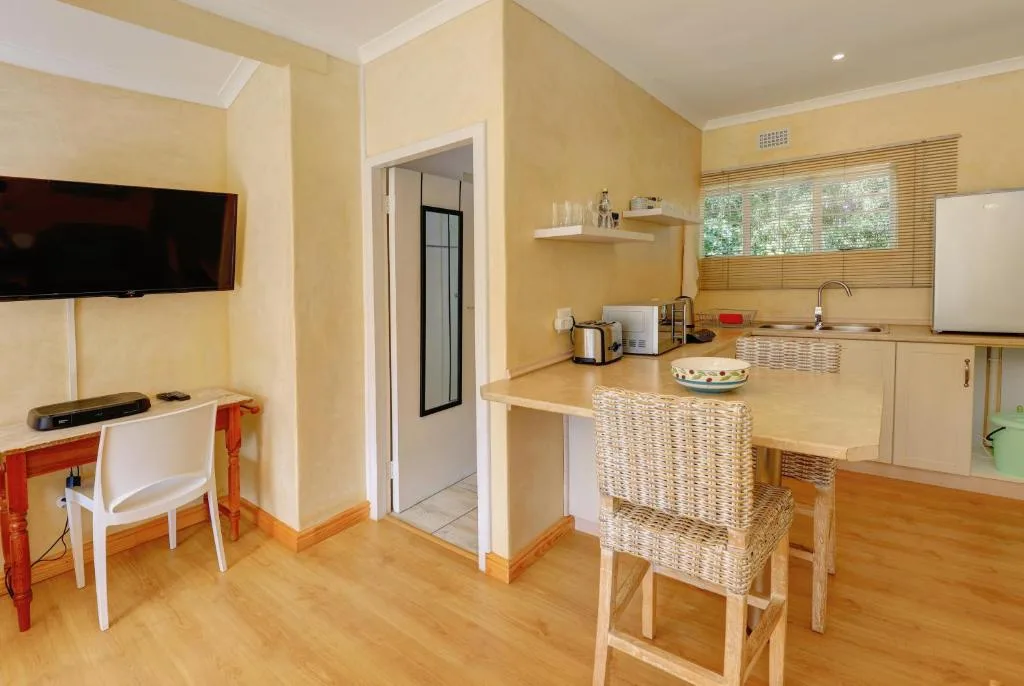 Modern kitchen with island counter, white cabinetry, and yellow walls