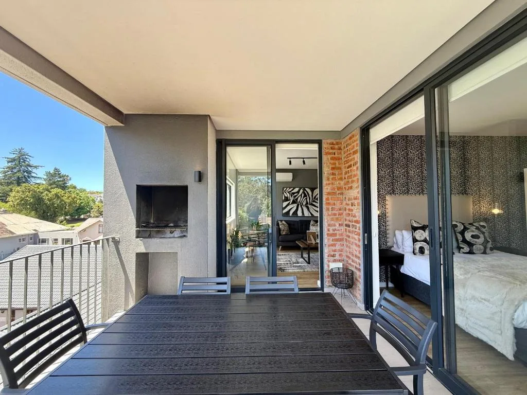 Spacious deck with seating overlooking garden and surrounding landscape