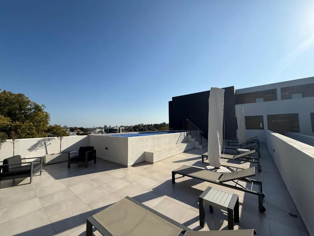 Spacious rooftop terrace with loungers and lagoon views