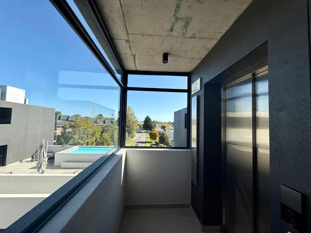 Modern balcony with pool view and surrounding landscape vistas