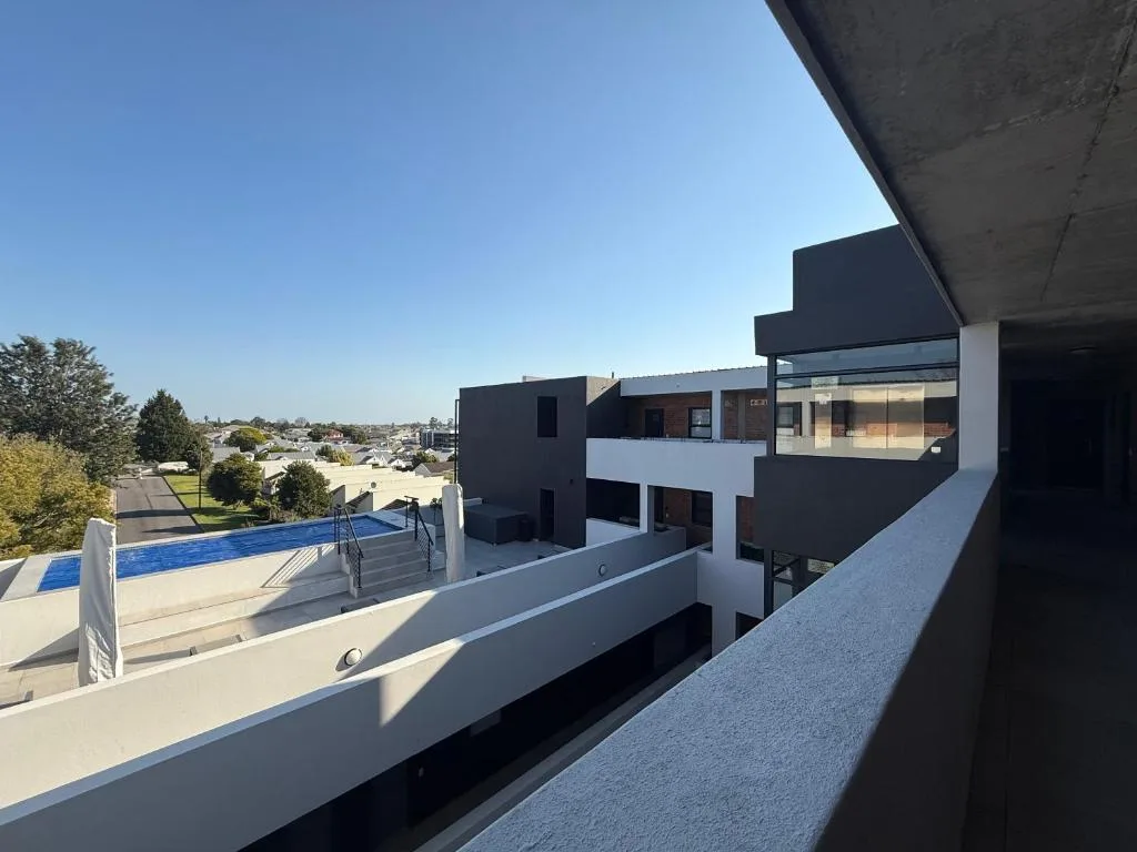 Modern apartment with pool and surrounding town landscape view
