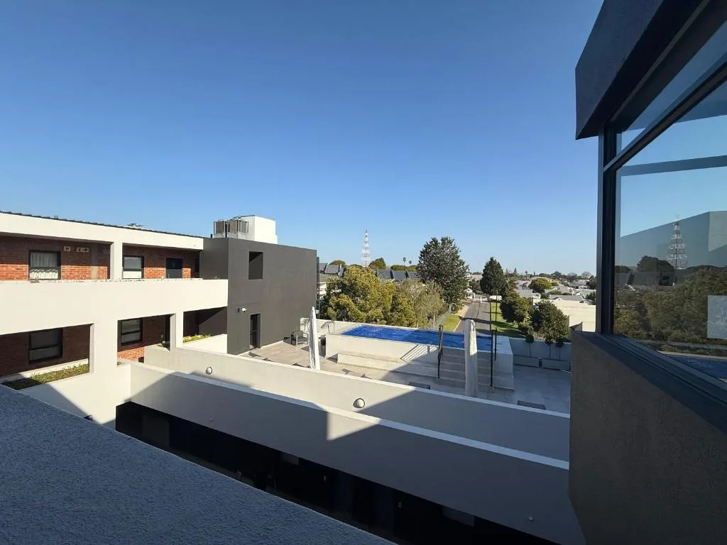 Scenic outlook over residential gardens and town landscape from deck