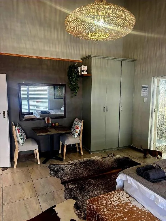 Modern bedroom with desk area, pendant lighting, and sliding wardrobe doors