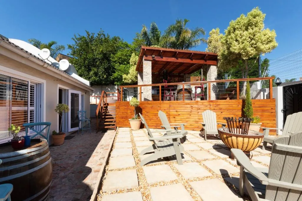 Spacious patio with Adirondack chairs, wooden deck, and braai area