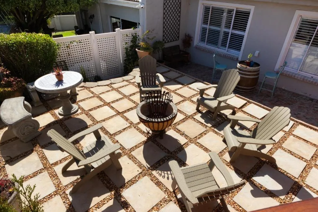 Spacious patio with loungers, fire pit, and outdoor seating areas