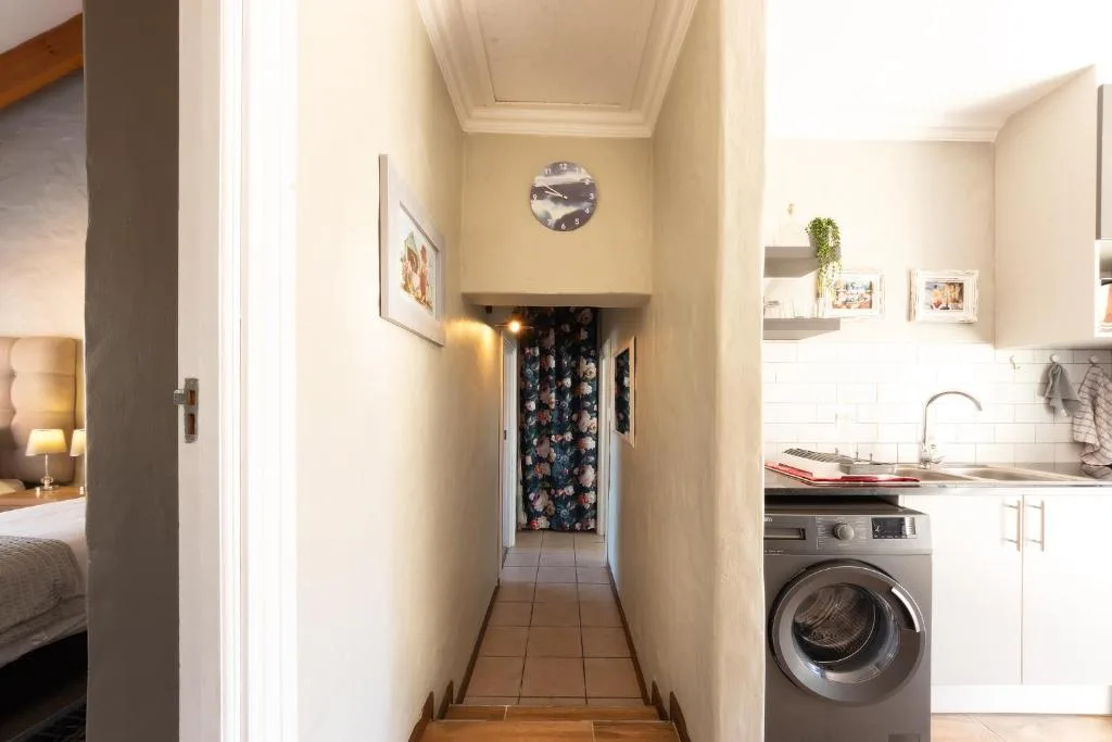Compact kitchen hallway with washing machine and modern appliances visible