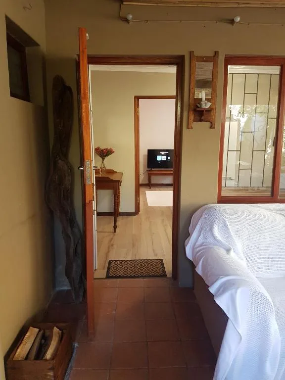 Spacious bedroom with ensuite entrance and white bedding visible