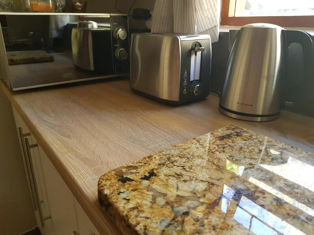 Kitchen counter with stainless steel appliances and granite worktop