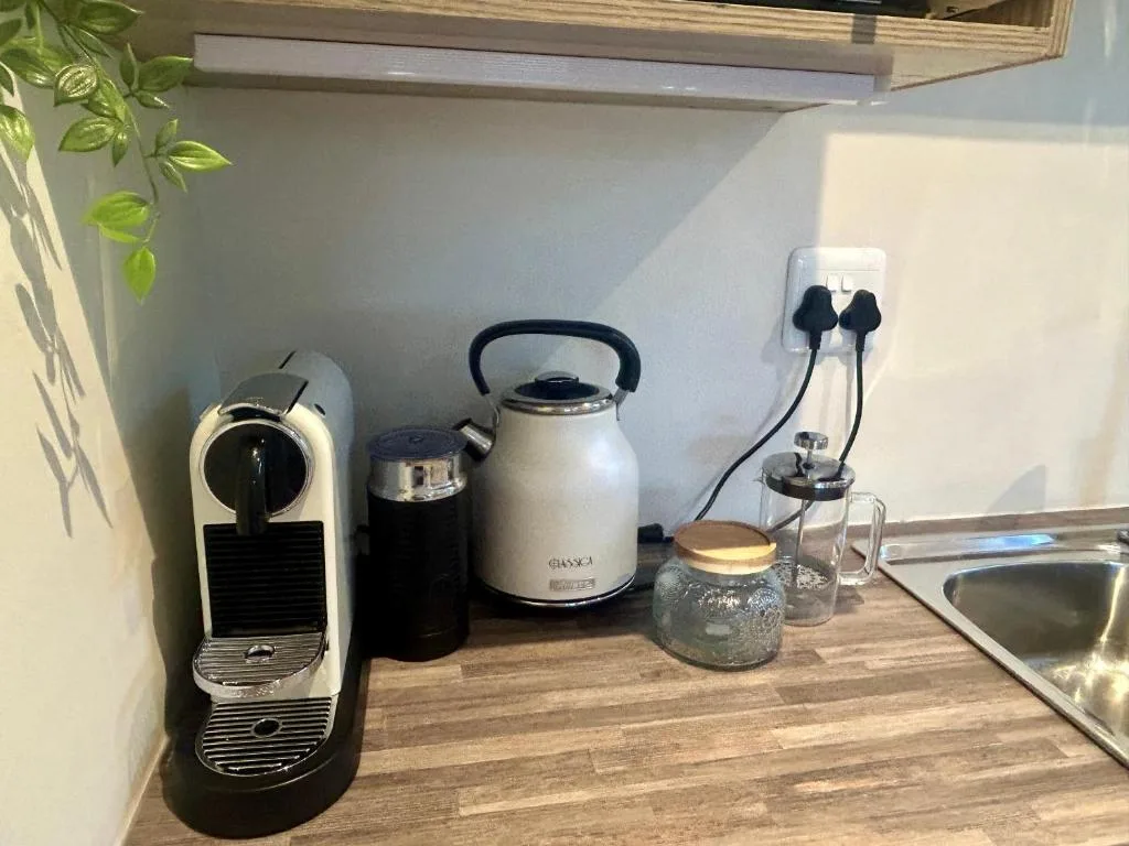 Kitchen counter with coffee maker, kettle, and appliances arranged neatly