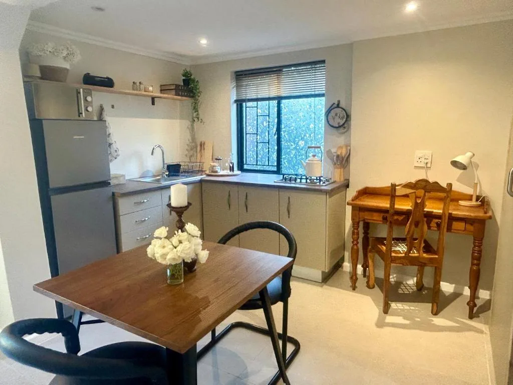 Open-plan kitchen and dining area with stainless steel appliances and wooden tables