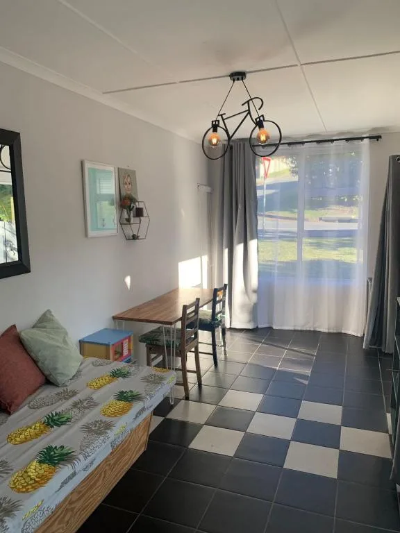 Bright lounge with bicycle pendant light and patterned sofa seating