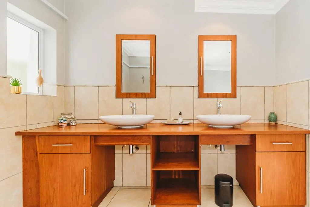 Spacious bathroom with dual vanity sinks and wooden cabinetry