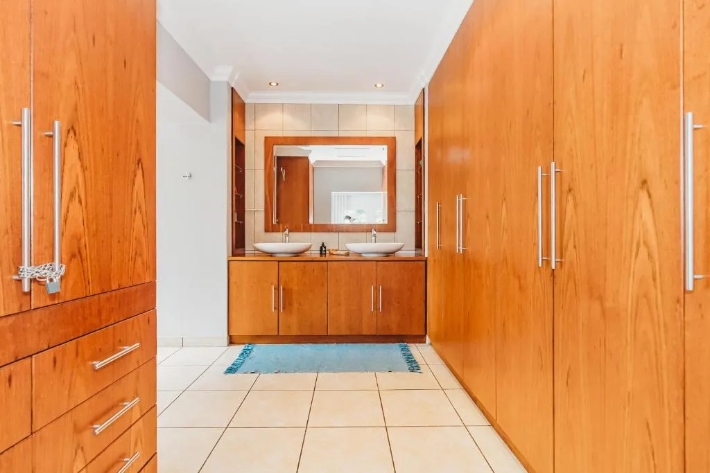 Modern bathroom with double vanity sink and wooden cabinetry