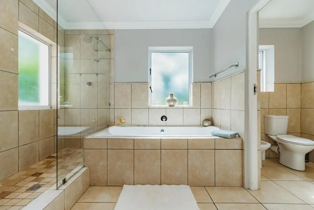 Spacious modern bathroom with soaking tub, walk-in shower, and toilet