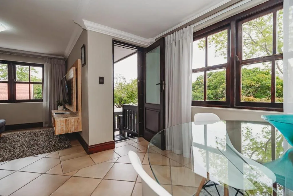 Bright open lounge with large windows overlooking garden and forest