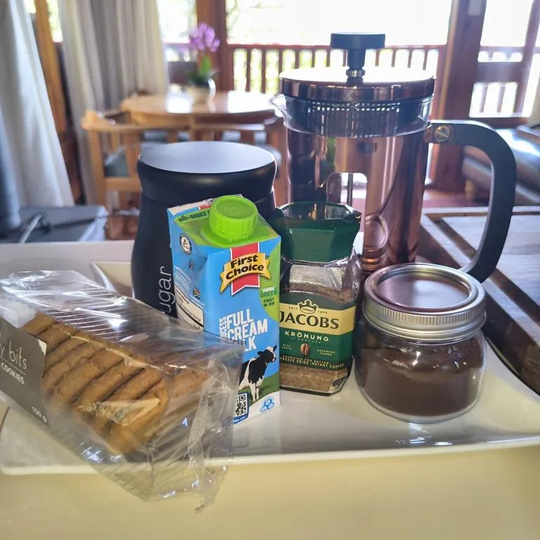 Coffee station with biscuits, milk, and instant coffee amenities provided