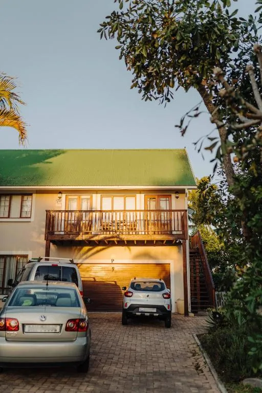 Garden Route home exterior with garage, driveway, and green roof