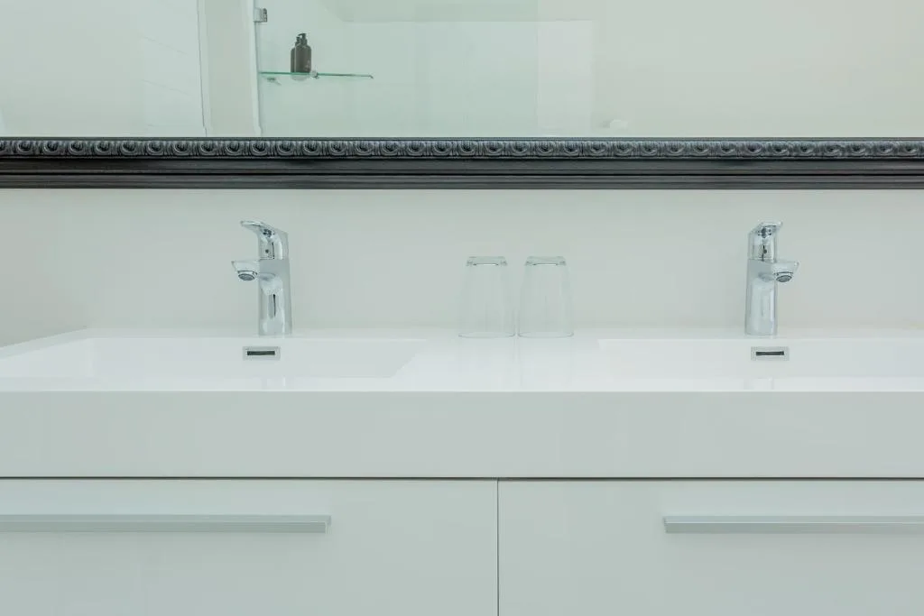Modern bathroom vanity with dual sinks and chrome faucets
