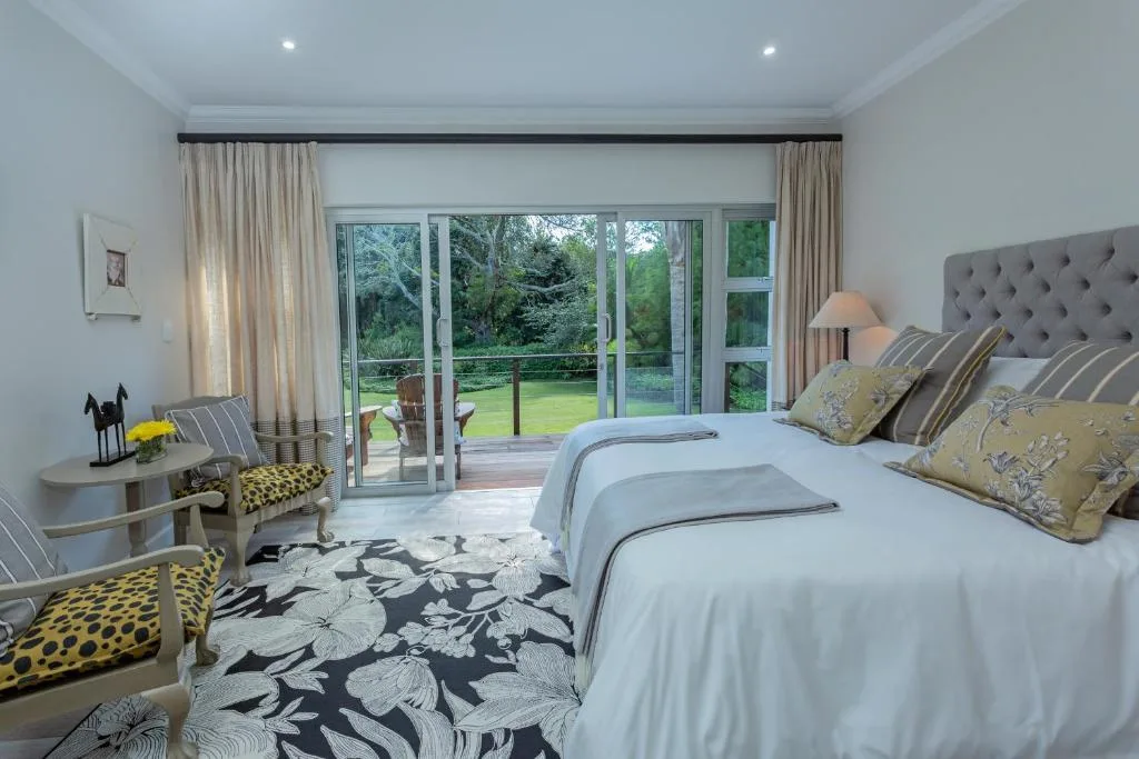 Bright master bedroom with garden views through sliding glass doors