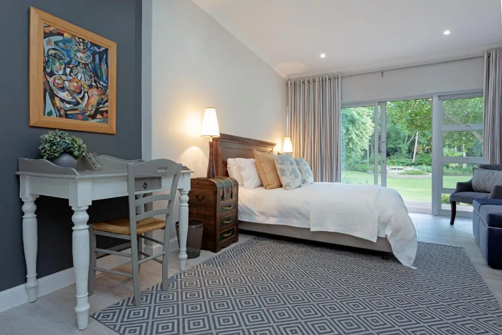 Spacious bedroom with queen bed, garden views through large sliding doors