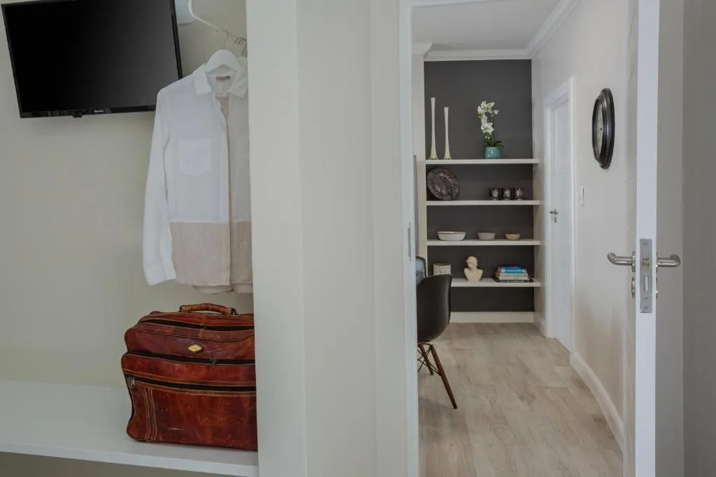 Modern hallway with built-in shelving, guest amenities, and decorative accessories