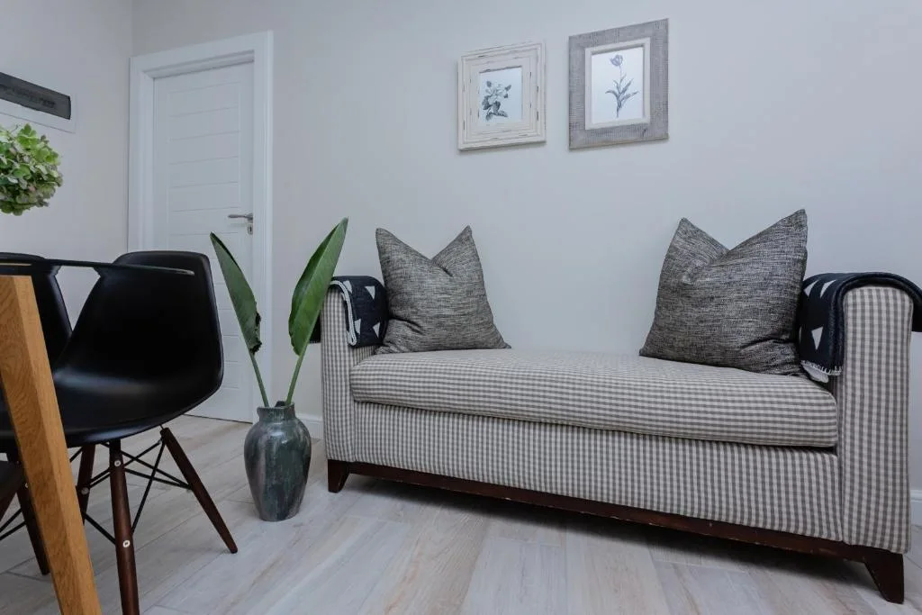 Modern lounge with striped sofa, gray cushions, and contemporary decor