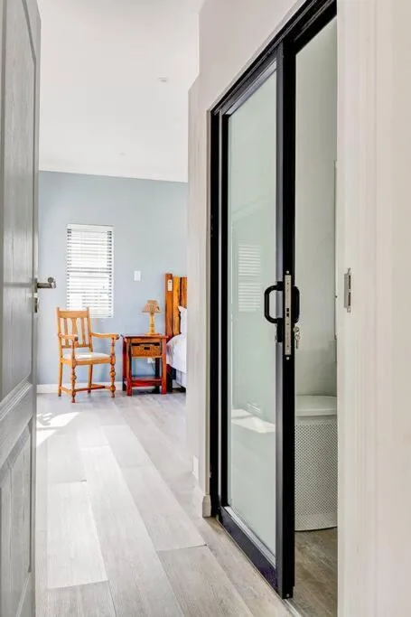 Modern black-framed sliding glass doors opening to bright interior space