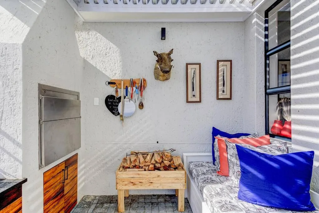 Cozy studio interior with braai table, wall art, and rustic decor