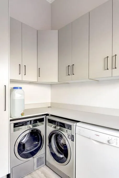 Modern laundry corner with front-load washer and dryer appliances
