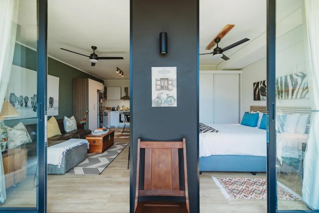 Modern bedroom with blue bed frame, white bedding, and coastal decor accents