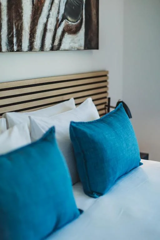 Modern bedroom with striped headboard and blue accent pillows