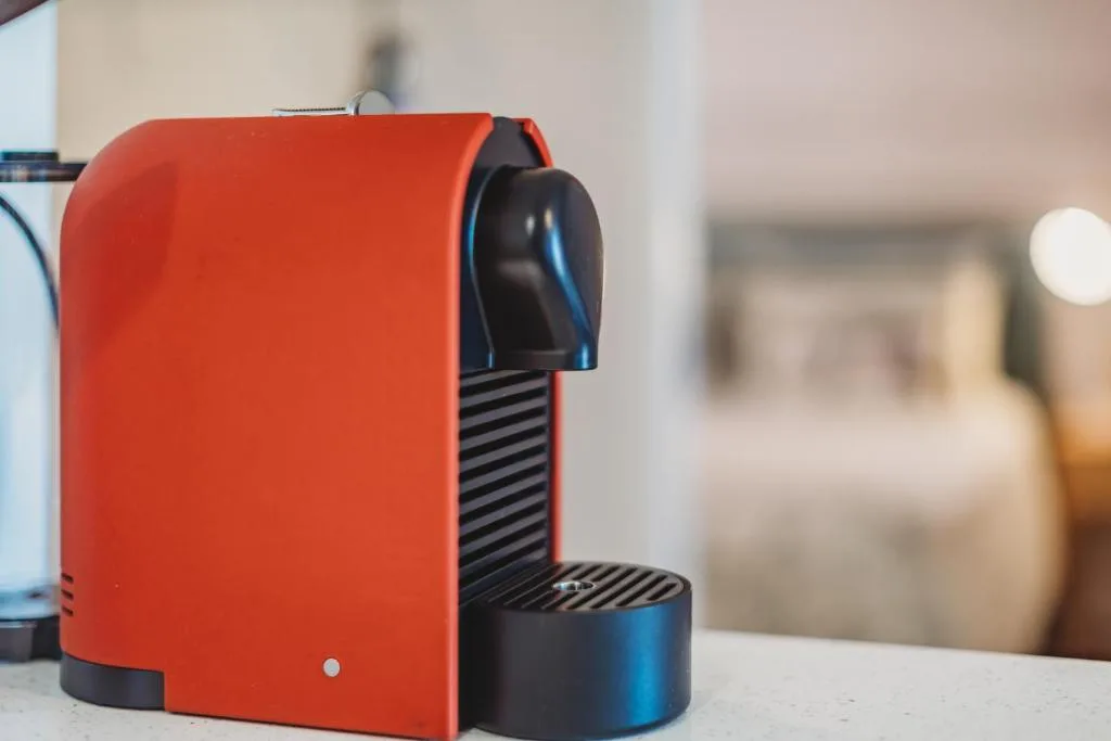 Red and black espresso machine on kitchen counter