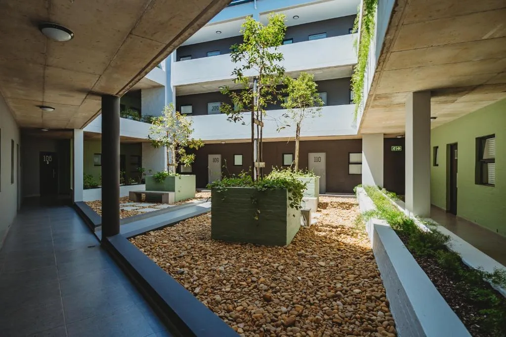 Modern apartment courtyard with landscaped planters and contemporary architecture