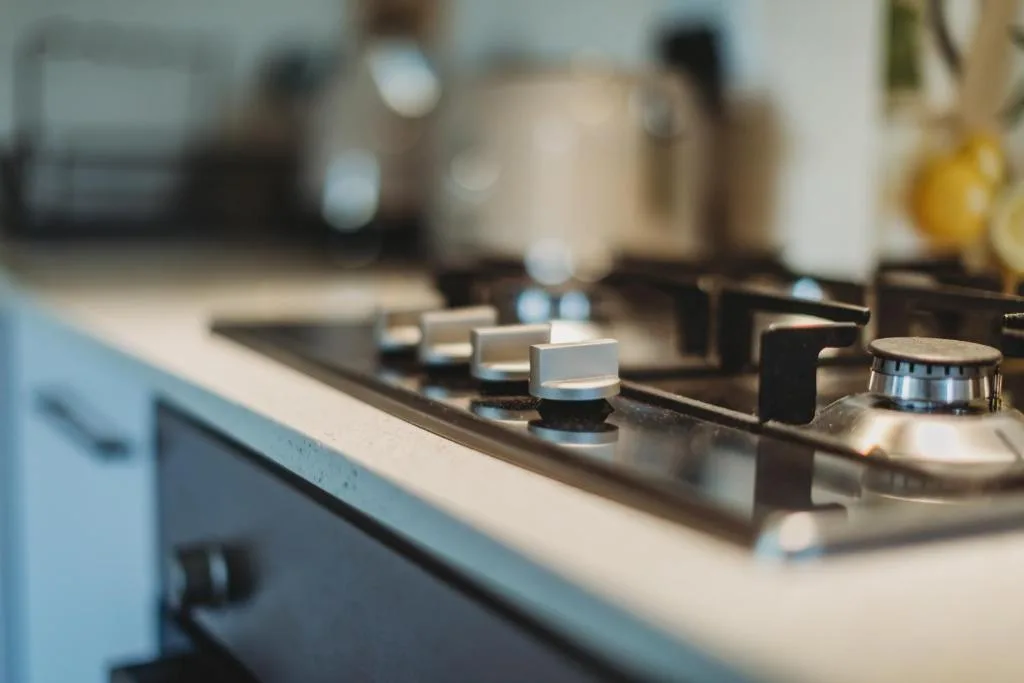 Close-up of gas stovetop with control knobs and burners