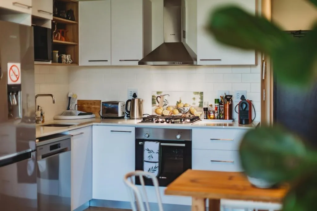 Modern kitchen with white cabinetry, gas cooktop, and stainless steel appliances