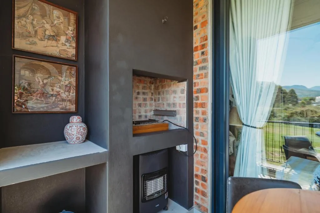 Modern lounge with fireplace, framed artwork, and mountain views through large windows