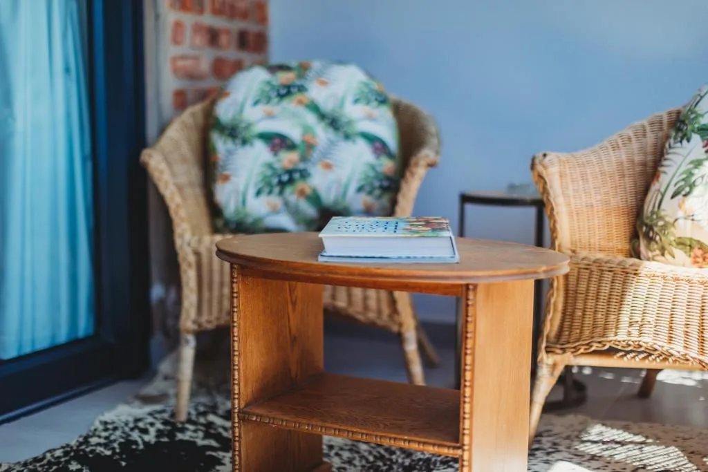 Comfortable lounge area with wicker chairs and decorative pillows
