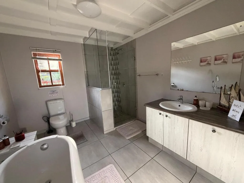 Modern bathroom with walk-in shower, dual vanity, and freestanding tub
